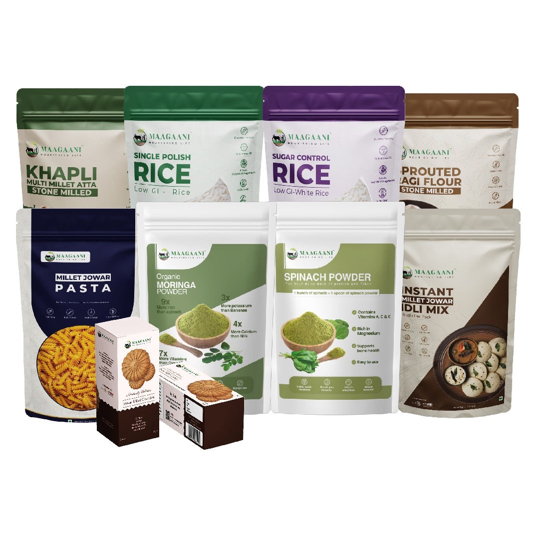 A collection of packaged food products from Maagaani, including bags of rice, atta, and flour, along with a box of cookies.